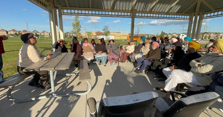 A doctor leading a health and well-being discussion with seniors during a speaker session.