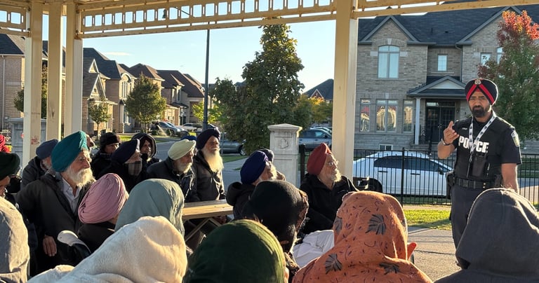 A Peel Police officer educating seniors on fraud prevention and personal safety during an event