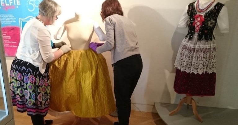 Mandy installing an eighteenth century dress in an exhibition