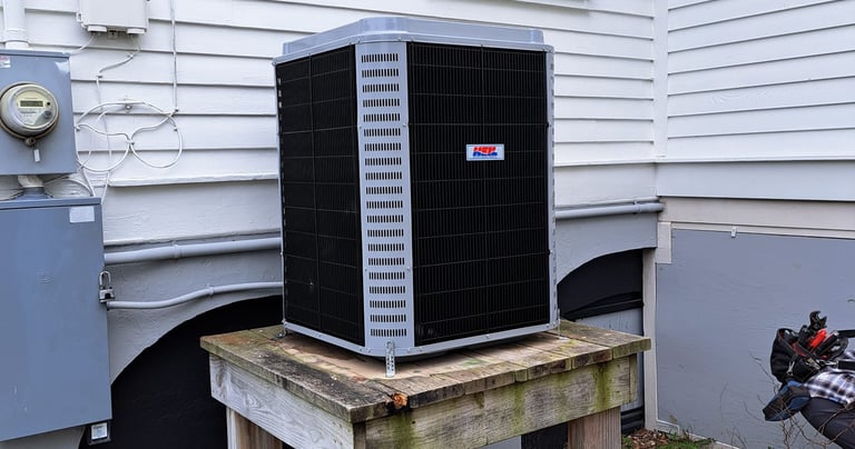 a small air conditioner sitting on a wooden table