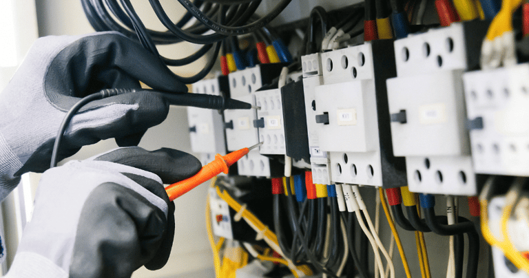 an electrician at work in an industrial warehouse