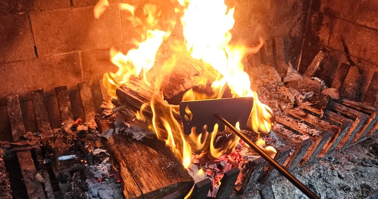 Extra long firerake being used on an outdoor fireplace in nz