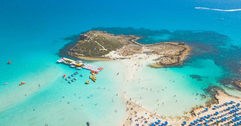 Cyprus beaches with clear water and sandy bays, popular spots like Coral Bay and Fig Tree Bay