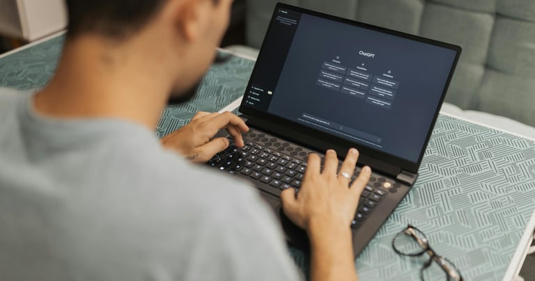 a man sitting on a couch with a laptop computer using chat GPT-4