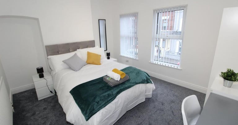 bedroom with bed and white walls
