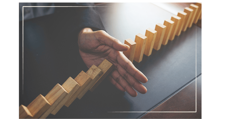 hand stopping blocks from falling over.