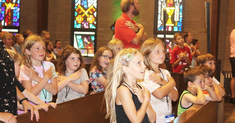 a group of children and adults in a church