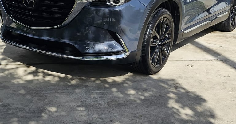 a mazda suv parked in front of a house