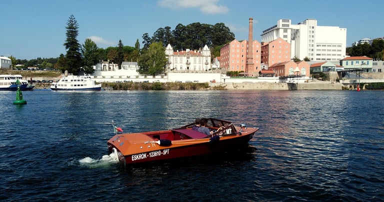 Private wooden speedboat cruising on the Douro River in Porto