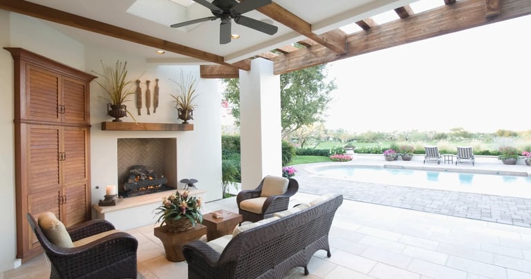 a patio with wicker furniture and a fireplace