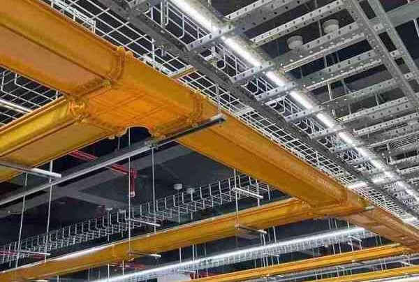 a ceiling with fiber cable trays and wire mesh cable tray and a ceiling light