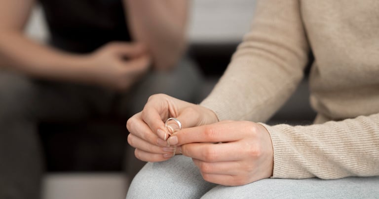a woman sitting on a couch holding a ring