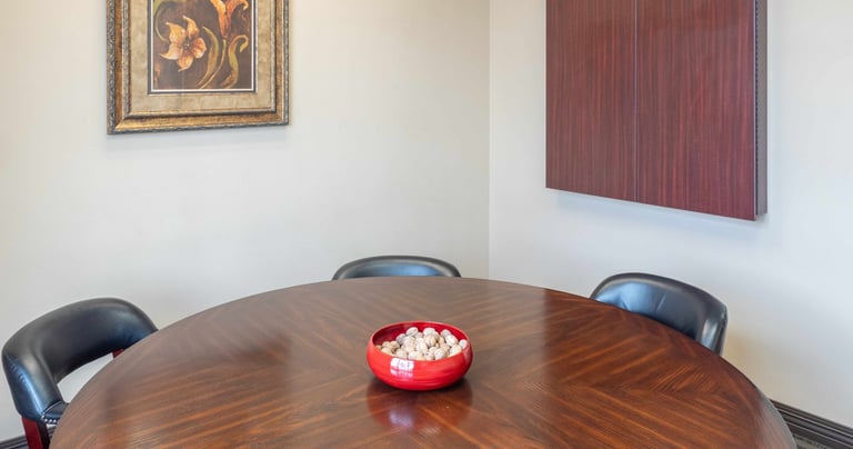 A bowl of walnuts on a table in a conference room