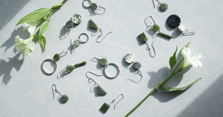 handmade pounamu earrings laid out on a table