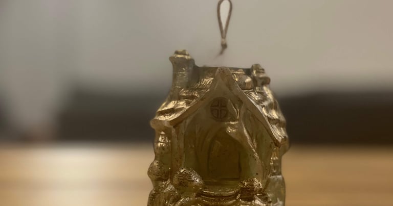 a small house with a small statue of a man