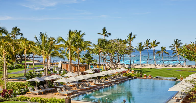 a pool with lounge chairs and umbrellas
