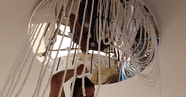 electricien installing chandelier