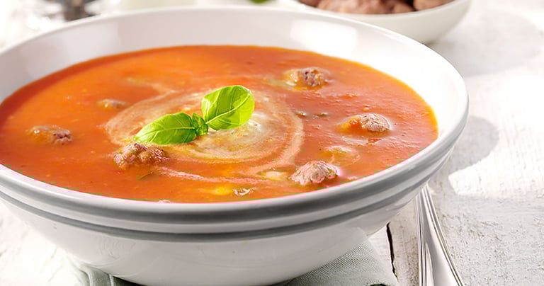 a bowl of soup with a slice of bread on top