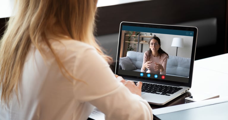 A photo of a coach conducting a 1 on 1 video teleconference call with an athelete