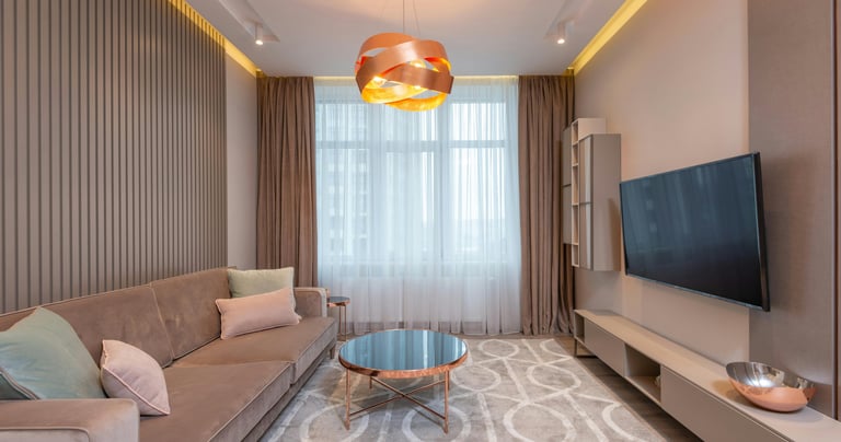 A sofa and a coffe table with a tv in a living room