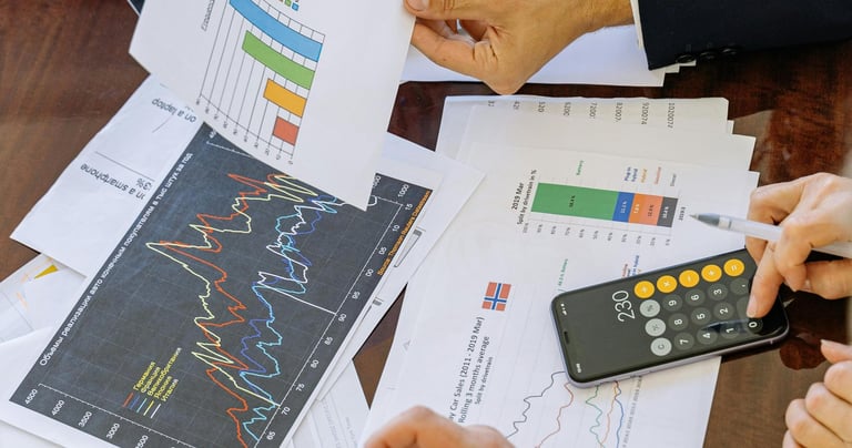 a few paper sheets with financial graphs on them