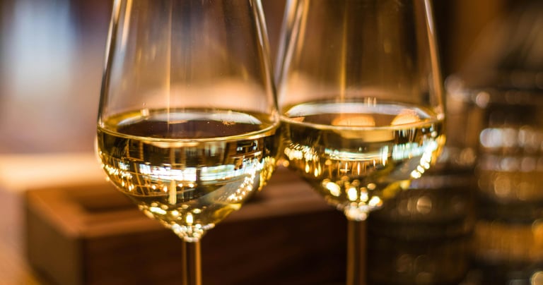 two wine glasses with wine glasses on a table