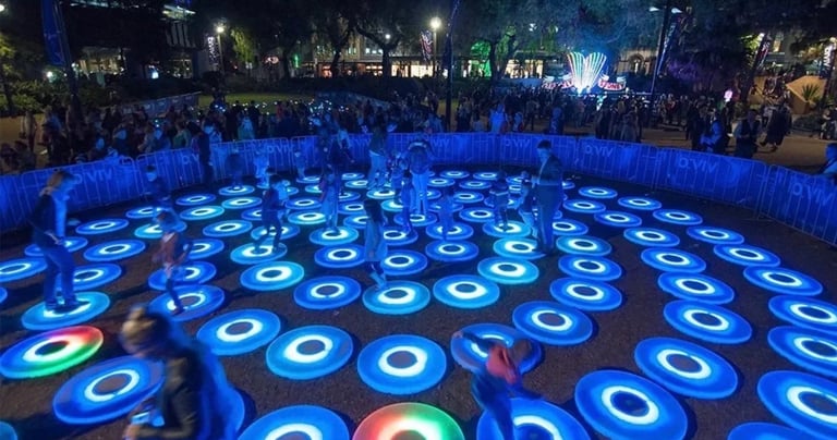 a group of people playing with frisbees in a circle