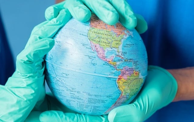 a person in gloves and gloves holding a globe