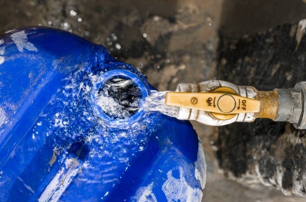 a blue water tank with a hose attached to it
