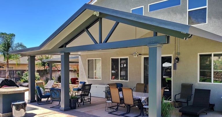 Patio cover with gabled roof line, fiberglass columns. and ceiling fan. Color is Graphite and White,