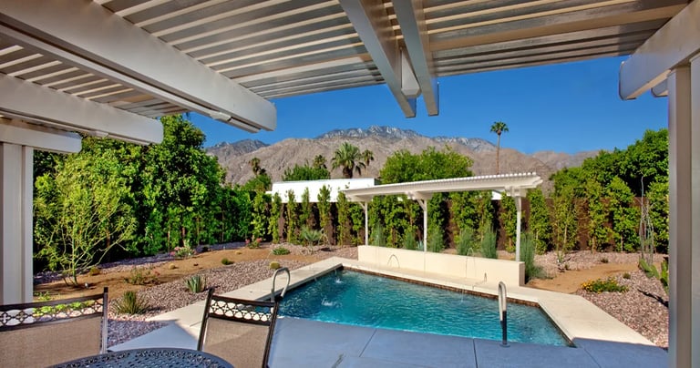 Patio cover with header above rafters with a veiw of pool.