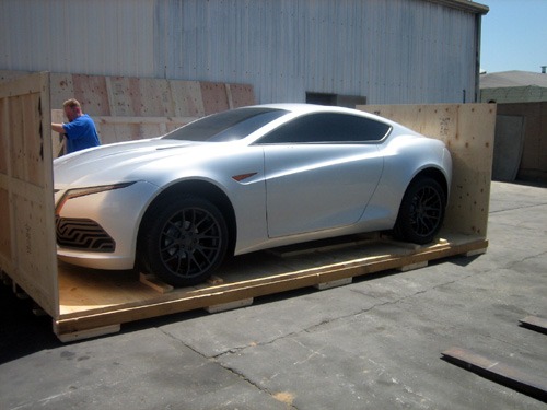 a car is being loaded into a custom crate