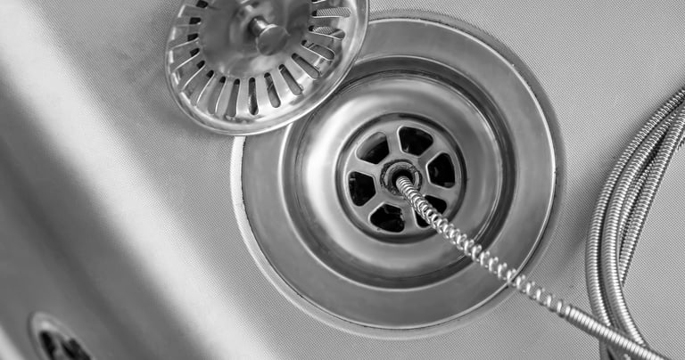 clearing a clogged drain with a snake in Surprise