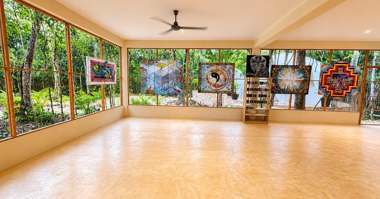 Spacious art gallery with psychedelic tapestries and panoramic windows overlooking a lush tropical forest.