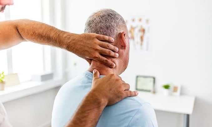 Physiotherapist treating neck pain performing mobilization, electrotherapy modalities and exercise.