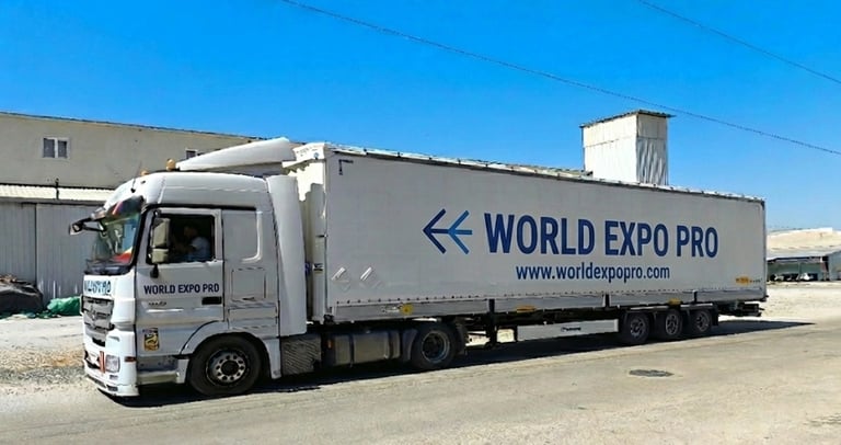a truck with a world of expo pro truck parked in front of a building