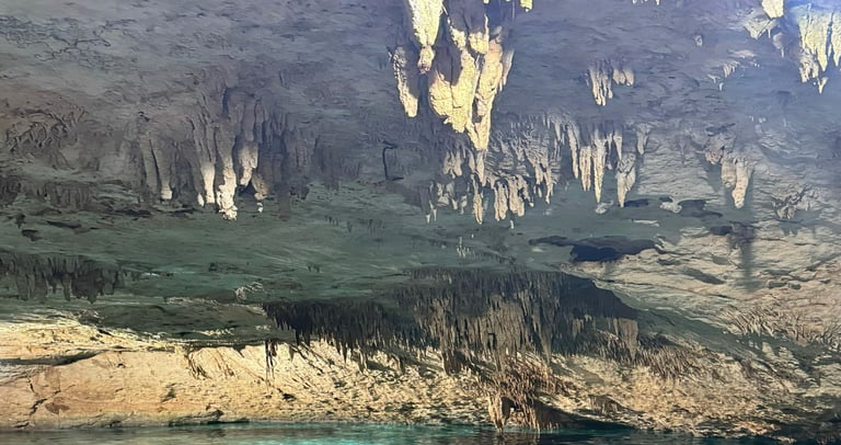 a person in a cave with a kayak