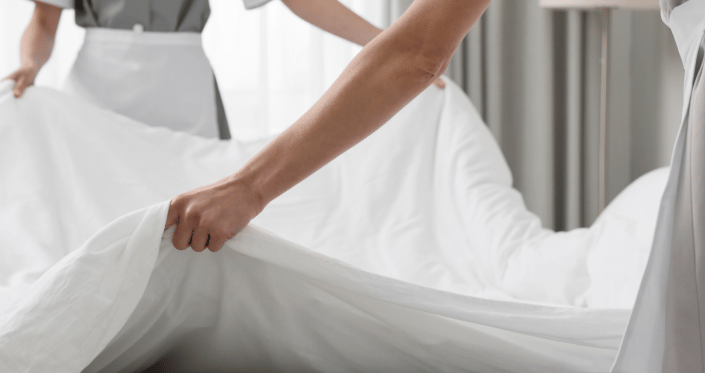 Personal de limpieza de hotel, haciendo la cama.