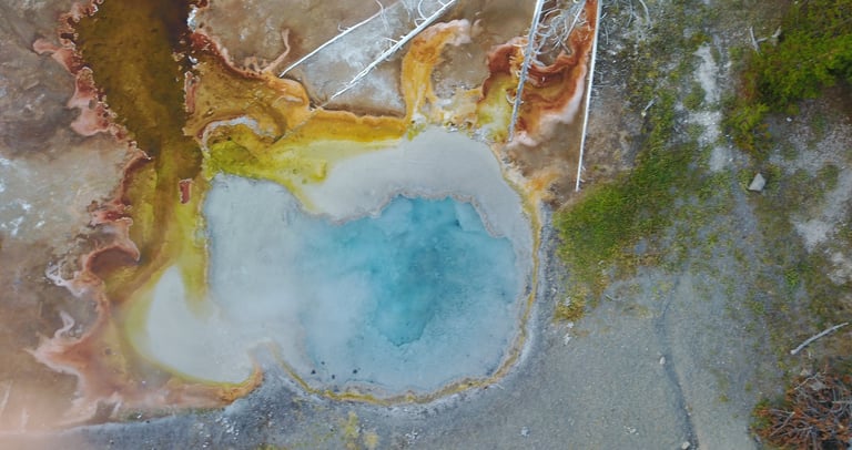 a large geothermal blue pool in yellowstone national park