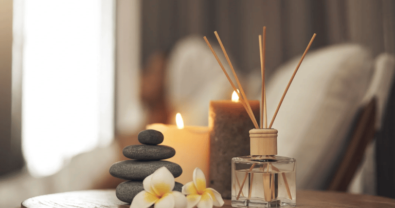 A medspa image of candles, incense, and balanced stones.