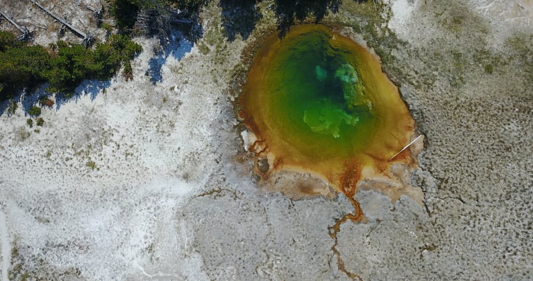 a large geothermal blue pool in yellowstone national park