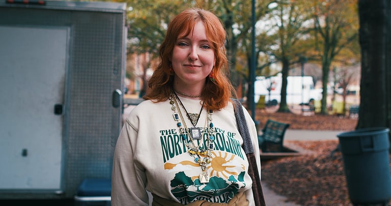 Young redheaded college woman smiling at camera.