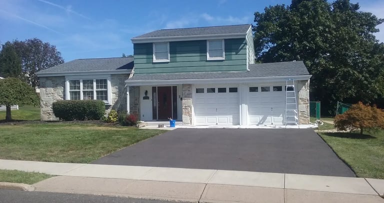 a house with a driveway and ladders 