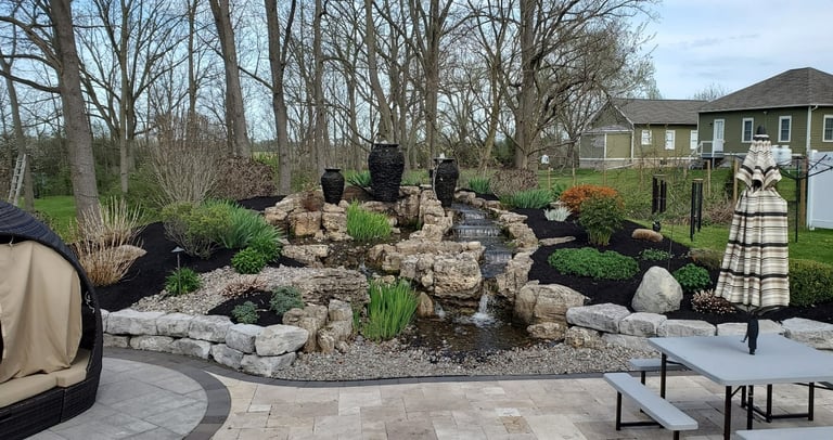 Custom backyard stone water feature and landscaping design by Mr. Grass, LLC in Canandaigua, NY