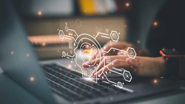 a person using a laptop computer with a laptop on the screen