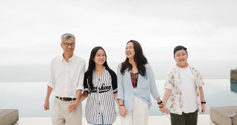 Family walking together at Alila Villas Uluwatu Bali with minimal architecture and soft tones
