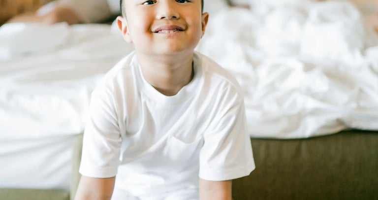 Child smiling during a playful family photography session at Anantara Uluwatu Bali.