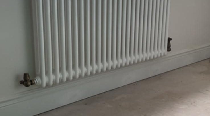 Compact radiator replacement in Evesham kitchen with clean pipework finish