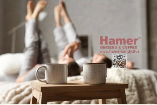 two cups of coffee and a woman in a bed hamer candy