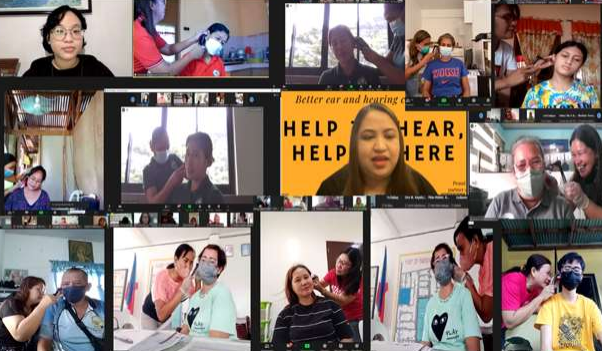 a group of people are gathered around a video conference